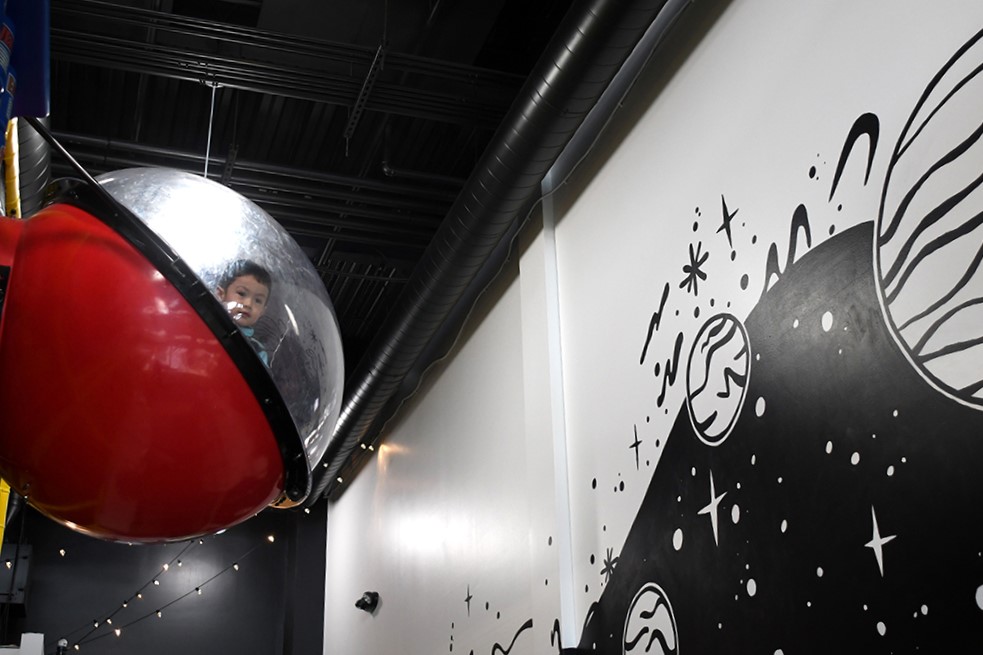 Seattle indoor playground Outer Space Seattle reopens for indoor play with a child peeking out from the space pod
