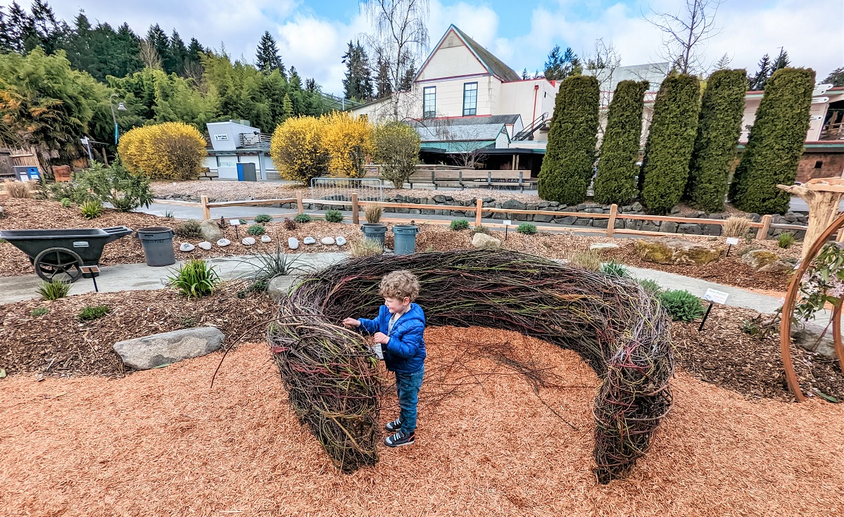 A boy plays in the giant bird nest at the new Little Explorers Nature Play Garden at Tacoma’s Point Defiance Zoo & Aquarium