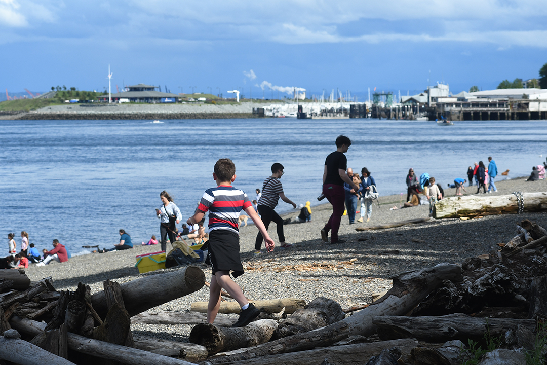 Kids play on the driftwood at Owen Beach on Tacoma's Commencement Bay the beach just reopened after a renovation it's part of Point Defiance Park