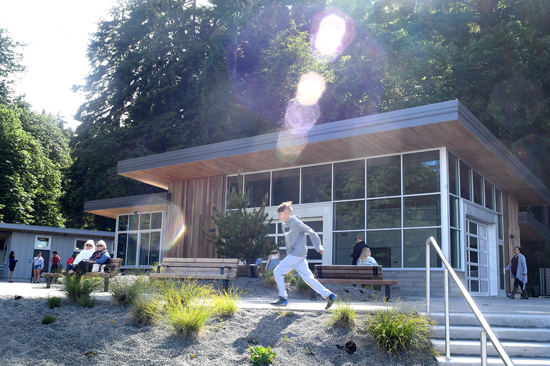 A boy runs in front of the pristine new pavilion building at Point Defiance Park's just reopened and improved Owen Beach