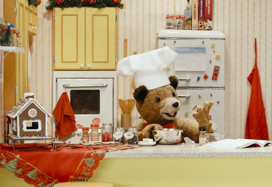 Paddington Bear in Seattle Children's Theatre production of Paddington Saves Christmas bakes a cake in the kitchen