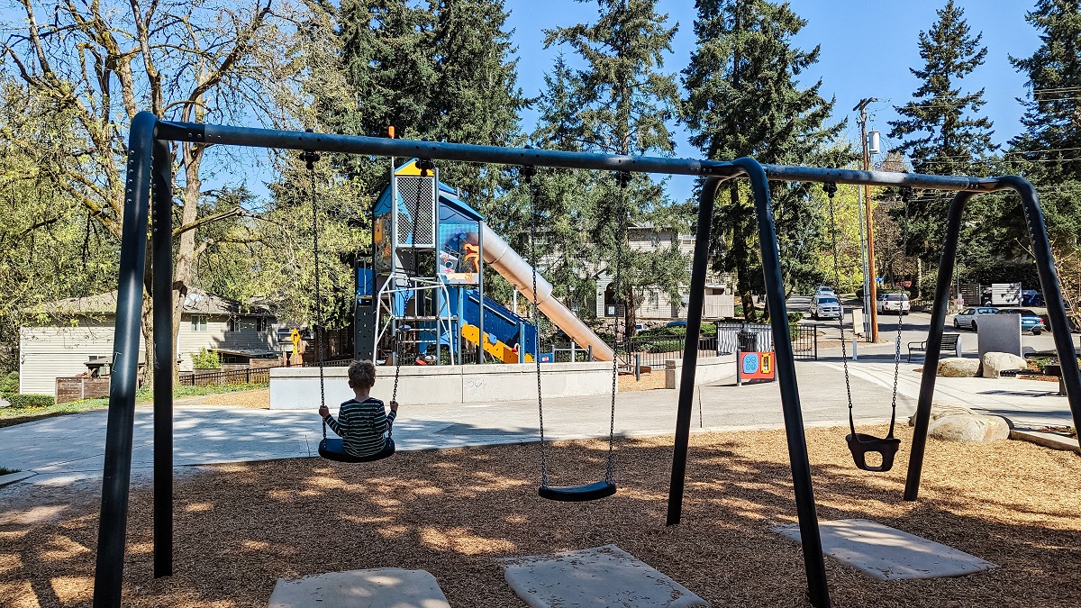 Swinging in the shade at Salt Air Vista Park playground in Kent, near Seattle