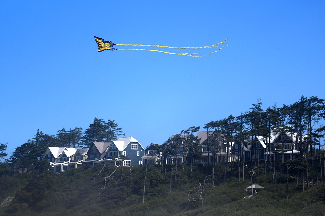 A kite flies in front of Seabrook houses on the bluff over looking the Pacific Ocean on Washington’s coast