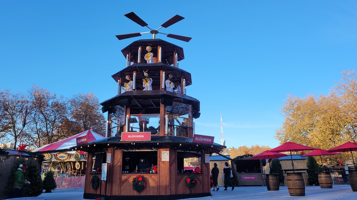 The Christmas pyramid or Gluhwein tower is the centerpiece of the Seattle Christmas Market and the venue for live music