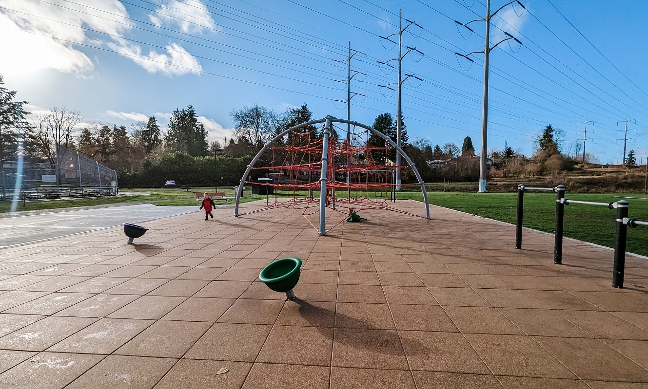 Kids play on a sunny winter day on simple yet engaging new playground at Skyway Park in Seattle and Renton