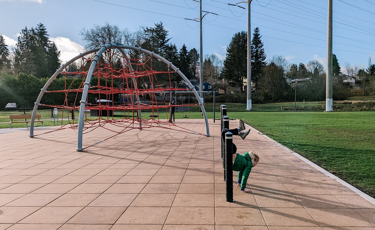 A girl plays on the monkey bars at Skyway Park's new playground in unincorporated Skyway, between Seattle Renton and Tukwila