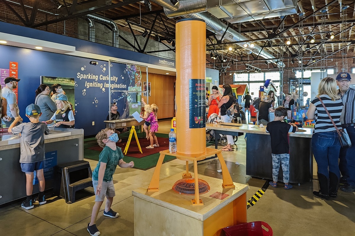 A young boy wearing a face mask plays with a fan tower at Mobius Discovery Center a kids' science museum in Spokane, Wash., family fun destination