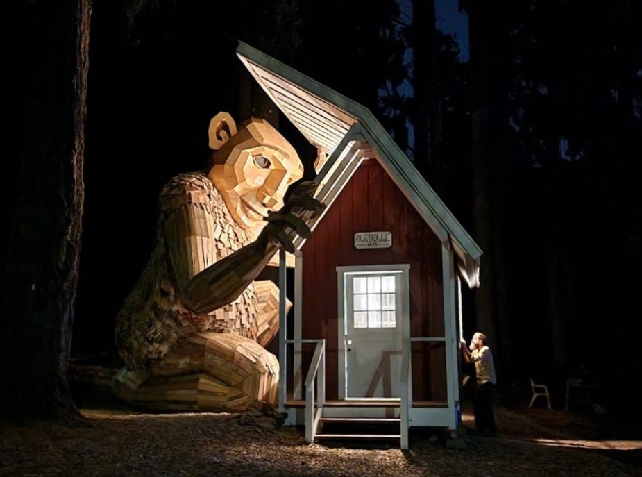 Portland Troll Ole Bolle by artist Thomas Dambo peeks into his playhouse at Nordic Northwest