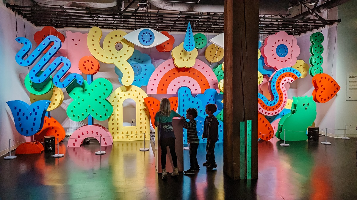 Kids interact with the colorful art piece that makes music (by artist Andy Arkley) at WNDR Seattle a newly opened interactive museum along the waterfront