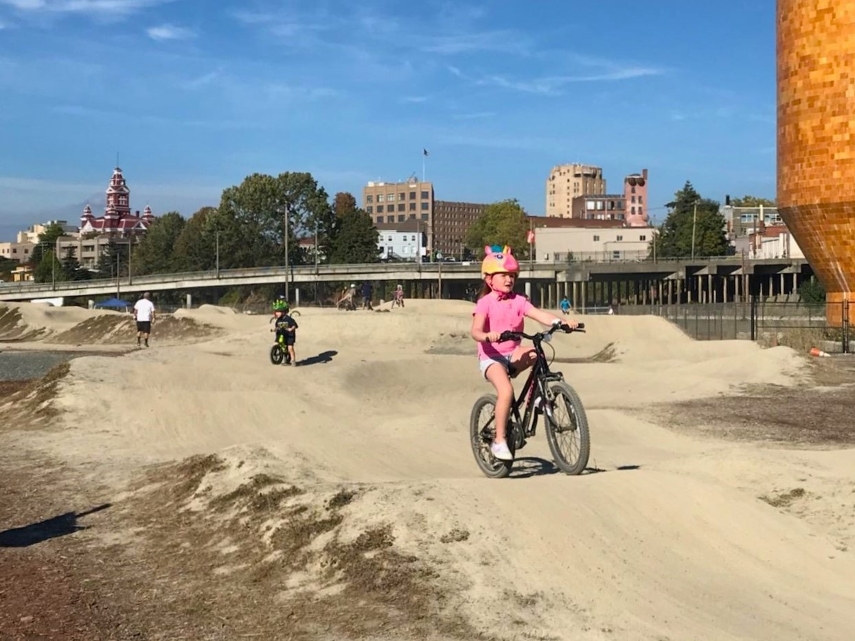 Kids ride the pump track at Bellingham’s newer Waypoint Park among fun free things to do in Seattle this summer