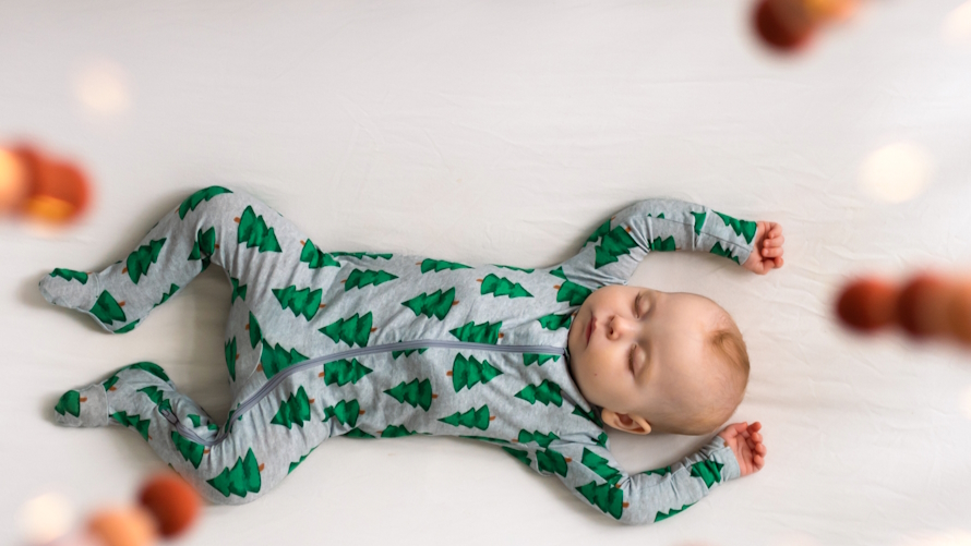 "Sleeping baby in Christmas pajamas"