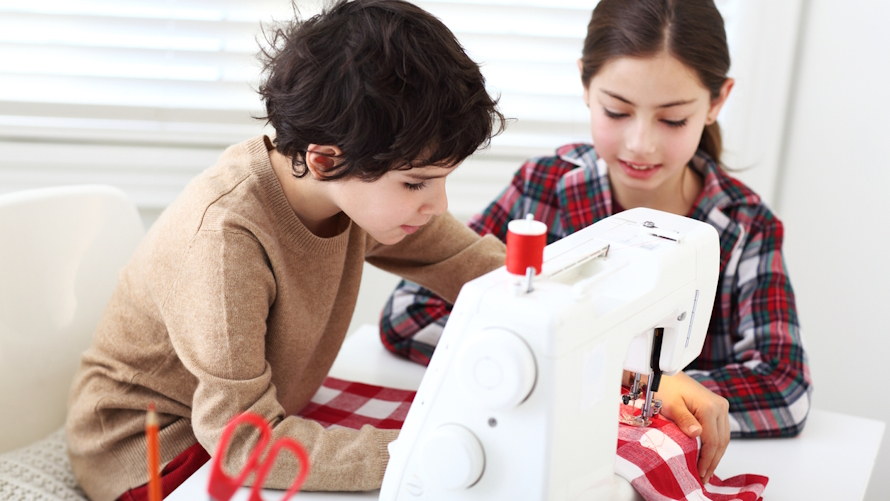 "Boy and girl sewing in a family competition based on a tv show"