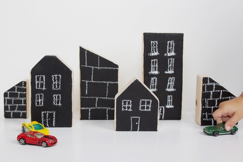 "Wooden blocks painted with chalkboard paint and drawn on to look like buildings"