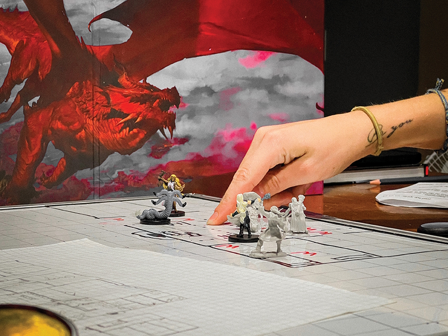 Hand on a D&D board moving pieces