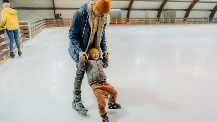 "dad and son ice skating one on one time together"