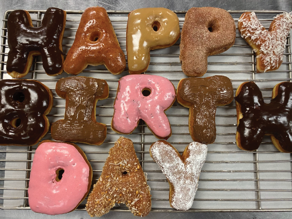 "Happy birthday spelled out in doughnuts"