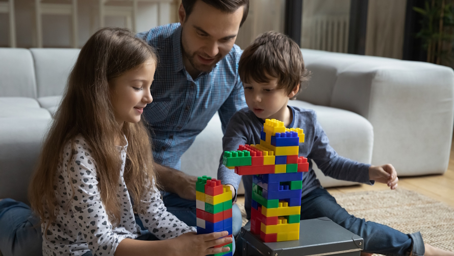 "Dad and kids building with Legos family competition based on a tv show"