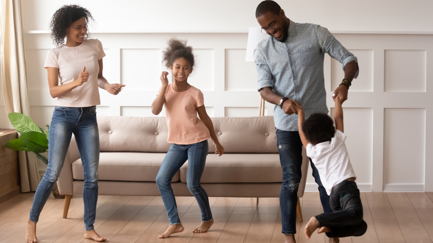 "Family having a dance party in their living room"