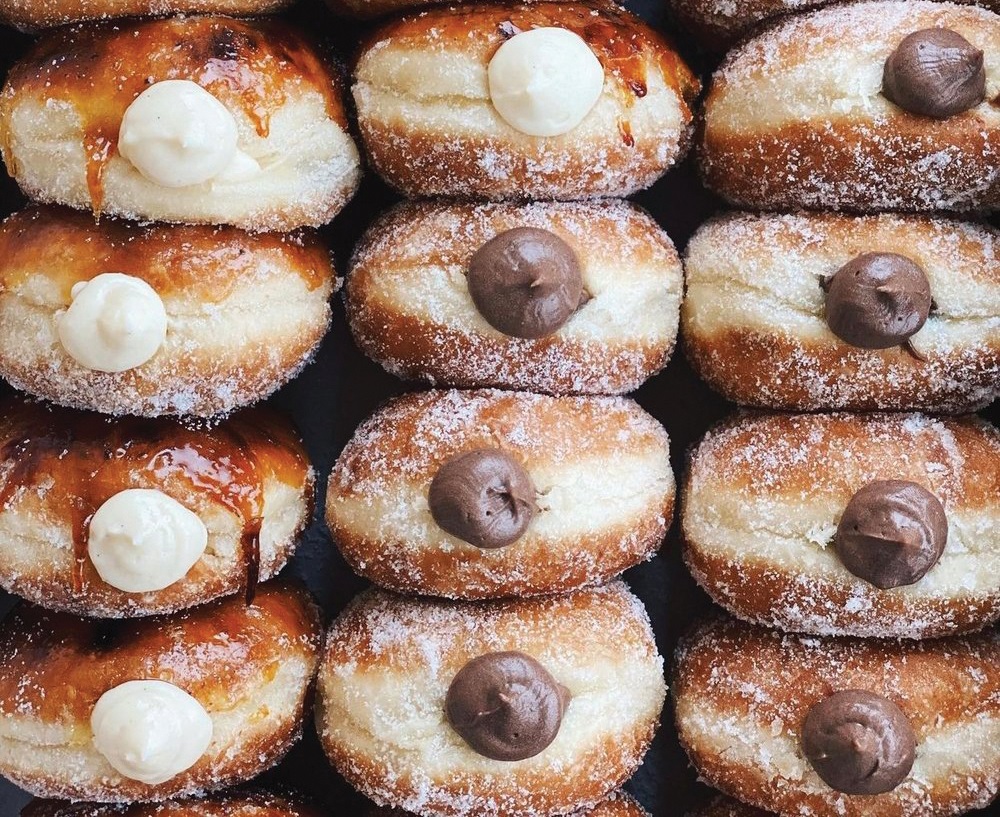 A delicious display of cream-filled doughnuts from The Flour Box bakery