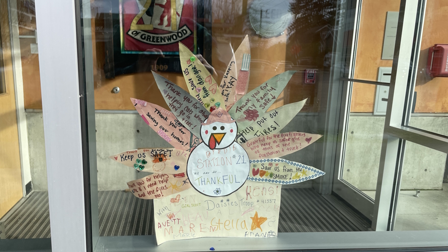 "Kind notes to firefighters on the window of a fire station"