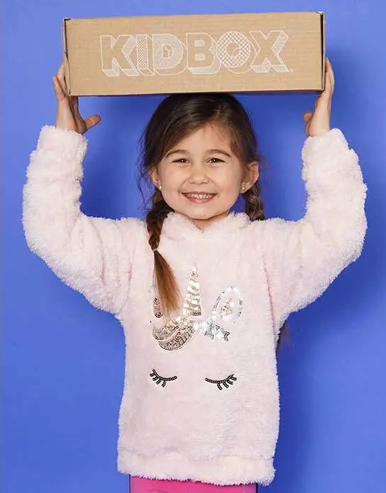 "Young girl holding a Kid Box over her head"