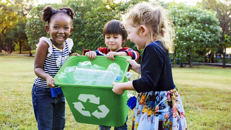 "Kids carrying a recycle box filled with plastic"