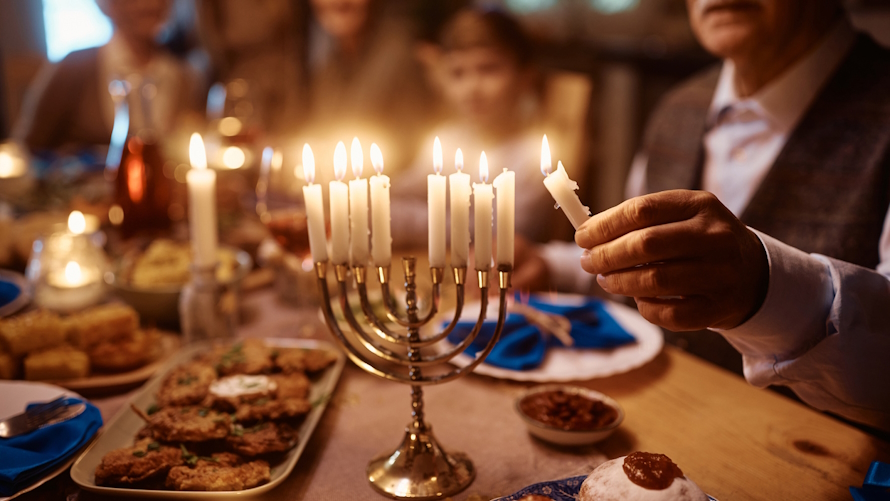 "Lighting the menorah with family"