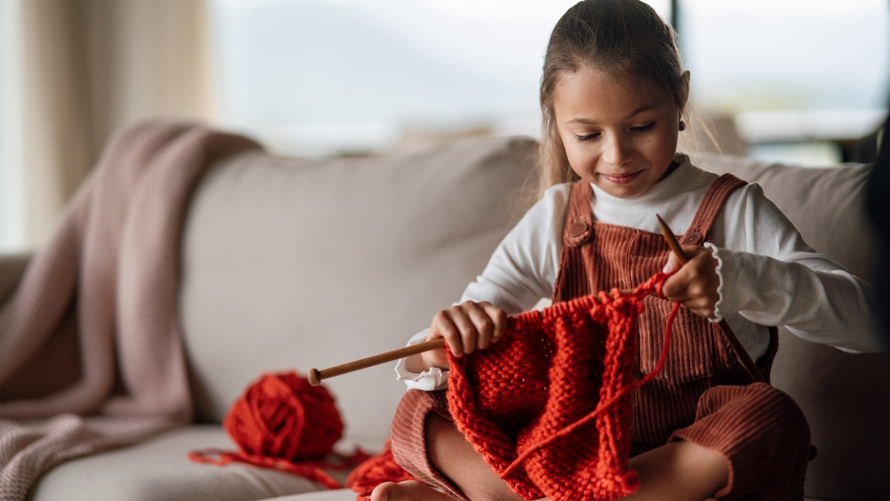 "Young girl knitting"