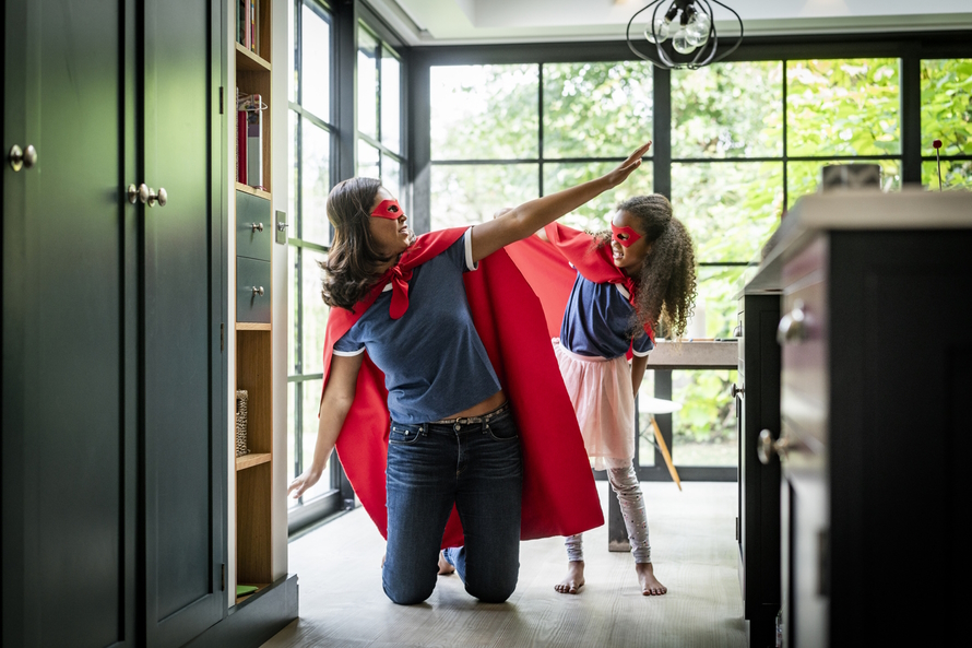 "Mom and daughter in super hero costumes"
