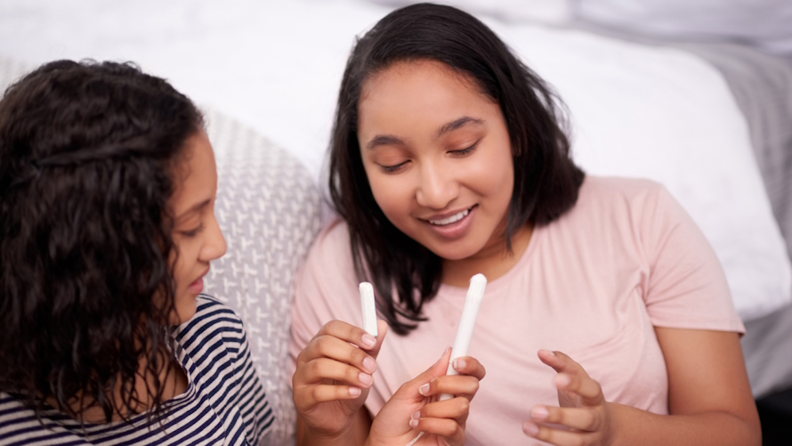 "mom and daughter talking with tampons"