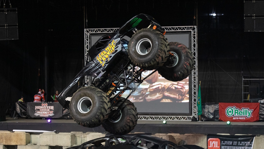 "Monster truck jumping over cars at the Washington State Spring Fair"