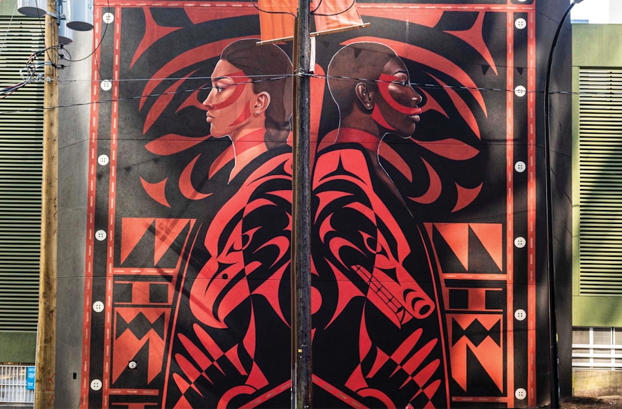 "Mural of two people back to back in Vancouver, BC"
