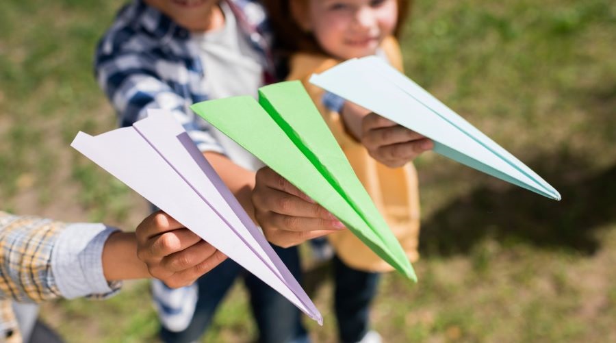 Kids show off the paper airplanes they made themselves