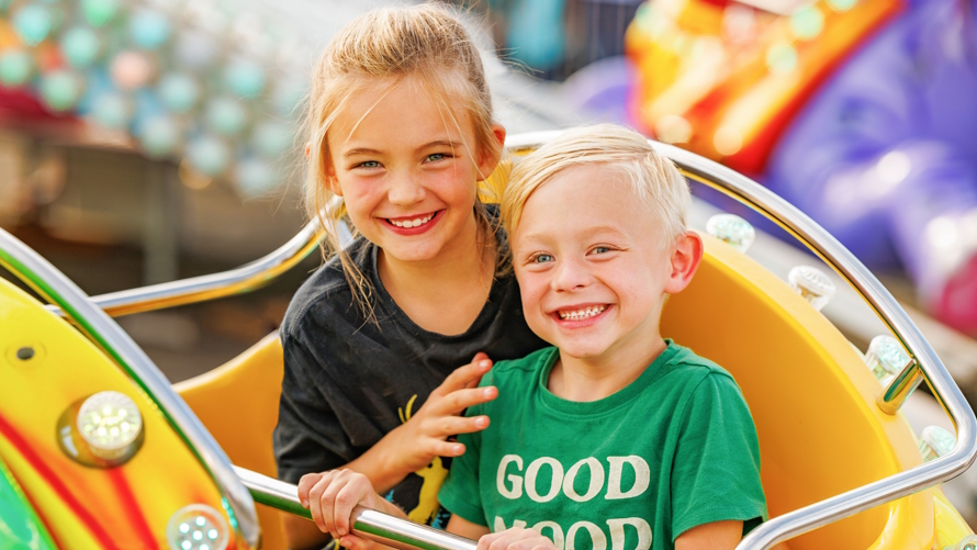"Two kids on a ride at the Washington State Spring Fair"