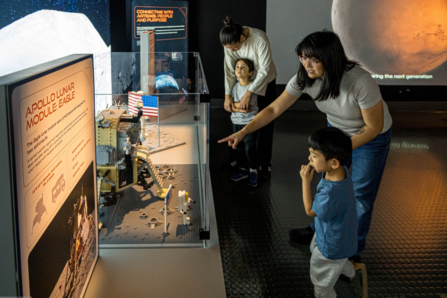 mom and kids looking at Artemis Lego exhibit