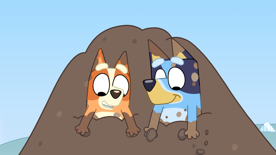 Bluey and Bingo are having a blast playing in a huge pile of dirt