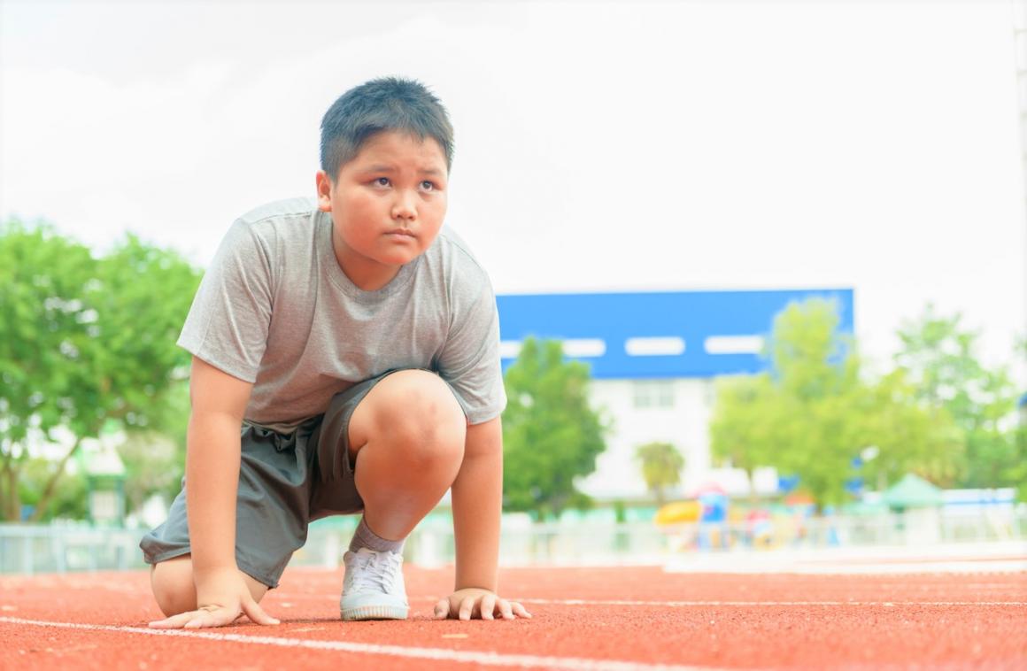 Boy lined up on a track about to start a race looking serious best ideas for your own backyard olympics