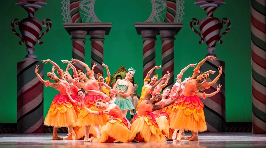 Ballet dancers in colorful dresses perform the Nutcracker.