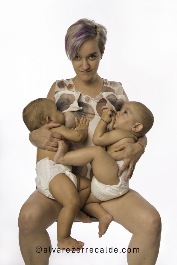 Mother breastfeeding her twins