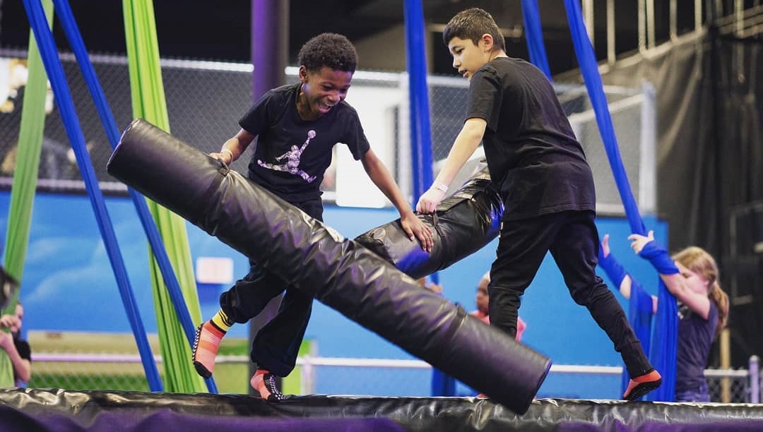 boys battle over a foam pit at defy seattle among top indoor play spaces around Seattle