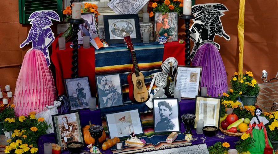 Personal photos and momentos serve as offerings in community altars at Day of the Dead events.