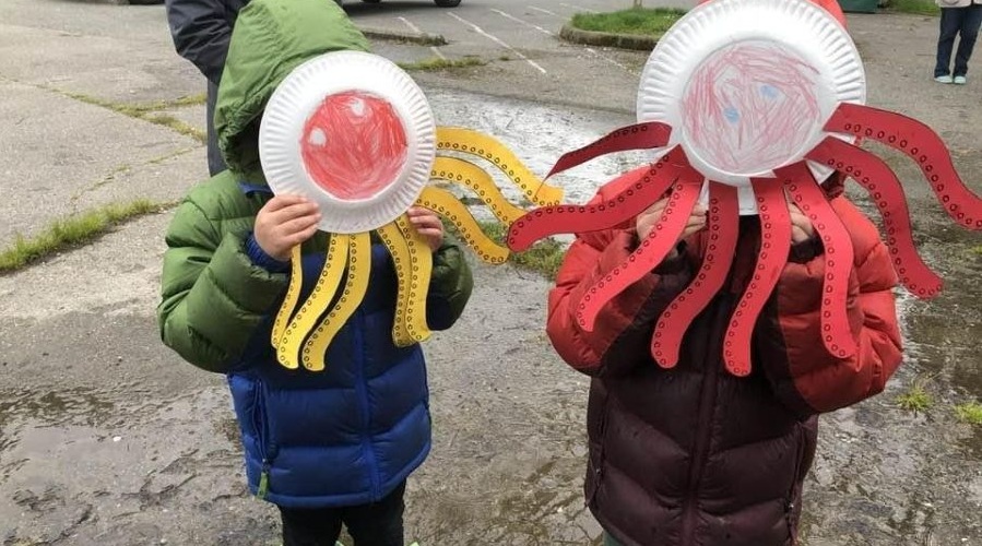 Kids make octopus crafts for Earth Day.