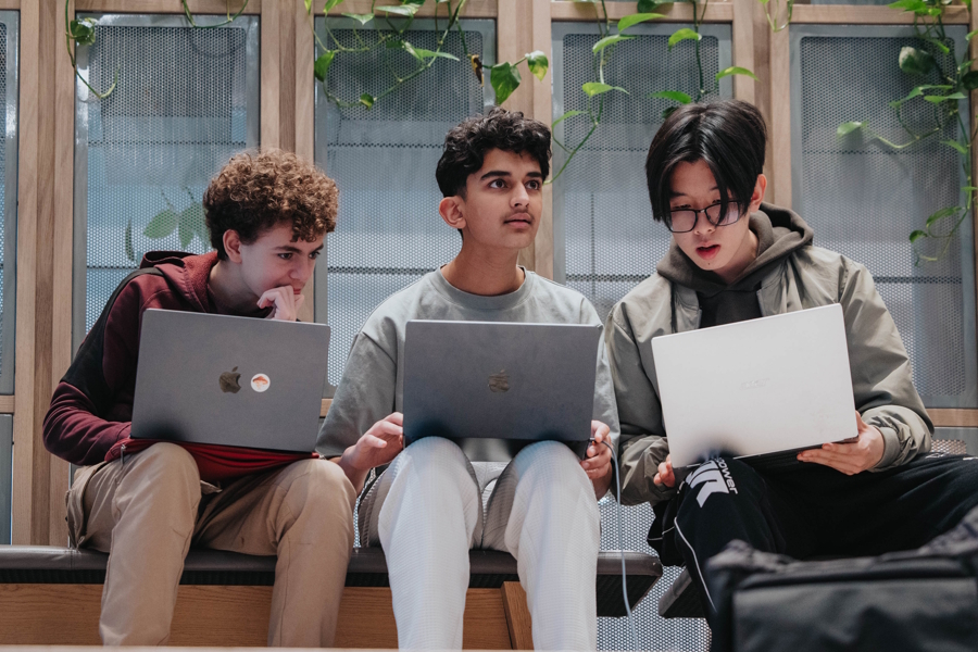 teens working together with laptops