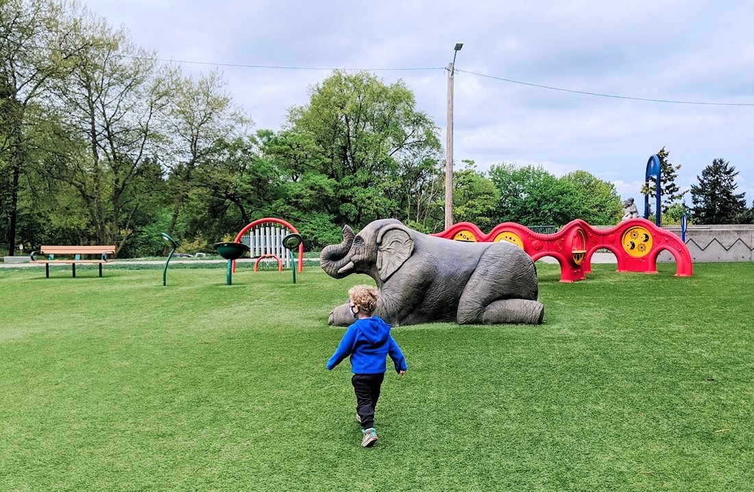 Child walks toward the statue of Rosie the Elephant at Forest Park playground