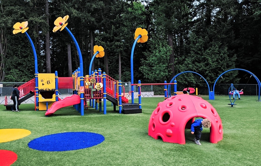 Tot area with lady bug play equipment playground new Forest Park Everett inclusive all abilities special needs