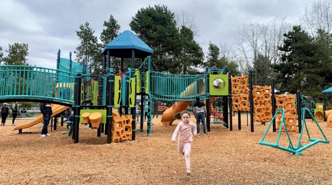 Young girl enjoys the new playground at Gene Coulon Memorial Park