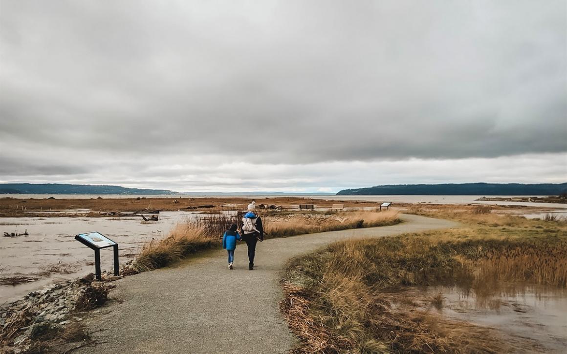 Family hiking at Fir Island farms in Washington’s Skagit Valley all season destination for Seattle families