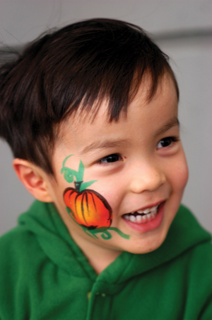 boy with pumpkin face paint