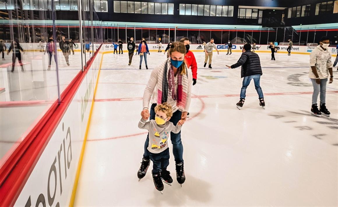 Author Natasha Dillinger and her son ice skating at new Kraken Community Iceplex in Seattle