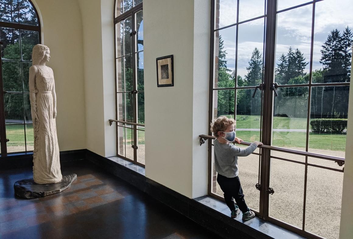 Boy looking out the window in historic Lodge at St. Edward State Park near Seattle upscale lodge renews old seminary building